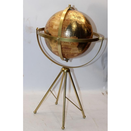 259 - World globe with twin axis 720° swivel on four brass legs, O/all height 54cms