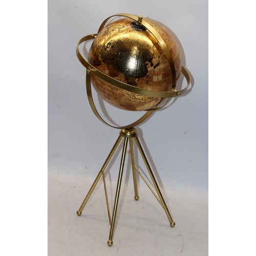 259 - World globe with twin axis 720° swivel on four brass legs, O/all height 54cms