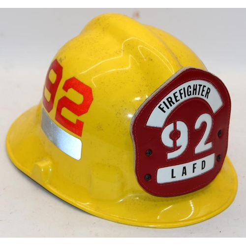 160 - Two Fireman's helmets, an American Ladder 92 LAFD helmet c/w a vintage Buckinghamshire Fire and Resc... 