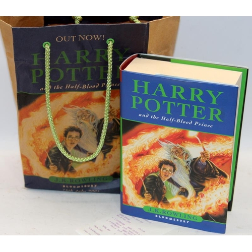 330 - 9 x Harry Potter hardback books, various titles c/w a Half Blood Prince retail paper bag dated first... 