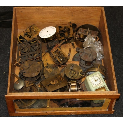 247 - Three large drawers of clock spares including dials and movements. Good lot to sort through