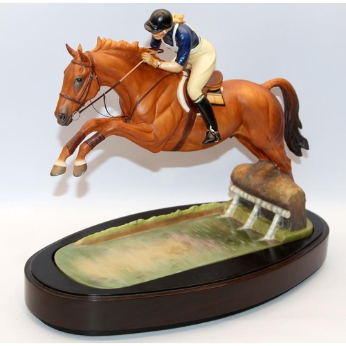 322 - Royal Worcester equestrian statuette of HRH The Princess Anne riding Doublet, taking a water jump. D... 