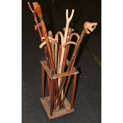 4 - Vintage wooden stick stand with cast metal drip tray containing a large collection of vintage walkin... 