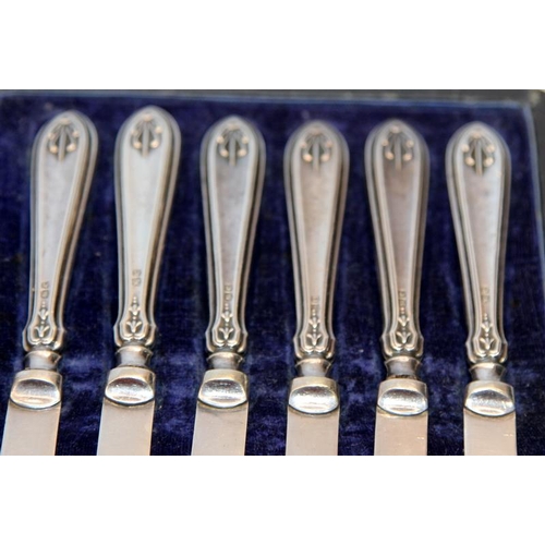 341 - A cased set of six silver handled butter knives with arts and crafts motif. Hallmarked for William Y... 