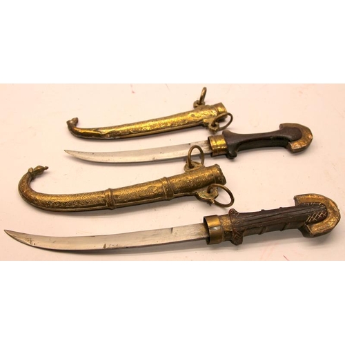 95 - Two antique Indo-Persian Jambiya daggers with ornate brass scabbards c/w a similar Arabian brass she... 