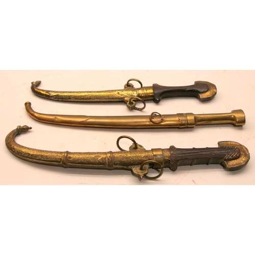 95 - Two antique Indo-Persian Jambiya daggers with ornate brass scabbards c/w a similar Arabian brass she... 