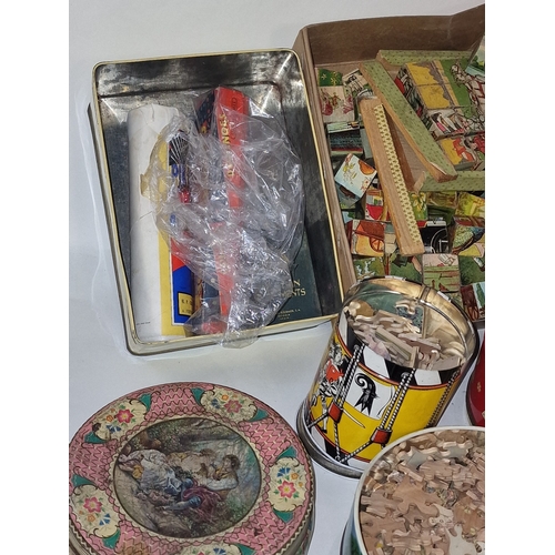 168 - Good collection of mainly vintage wooden jigsaw puzzles contained within several tins. Not checked f... 