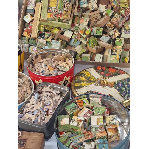 168 - Good collection of mainly vintage wooden jigsaw puzzles contained within several tins. Not checked f... 