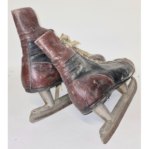 162 - A pair of vintage mid 20th century leather ice skates.