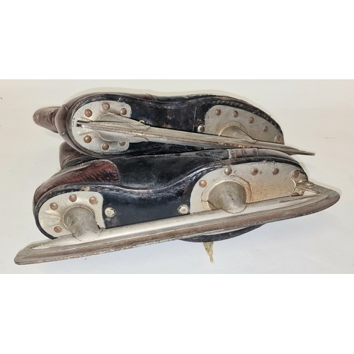 162 - A pair of vintage mid 20th century leather ice skates.