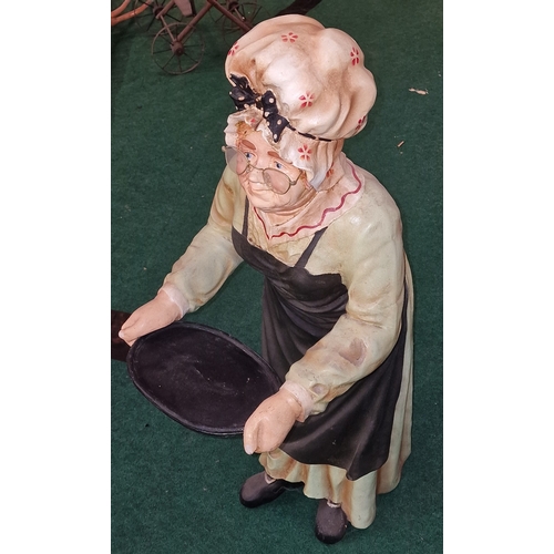 193 - Standing fibreglass model of an elderly lady holding a tray 100cm tall.