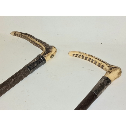 48 - A pair of vintage bone handled riding crops both with silver hallmarked collars.