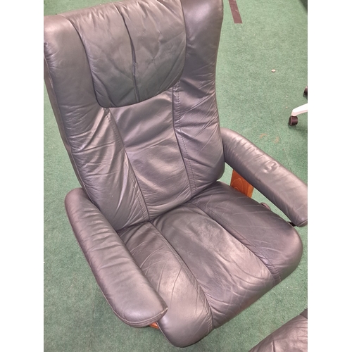 245 - Ekornes Stressless reclining leather armchair with matching footstool.