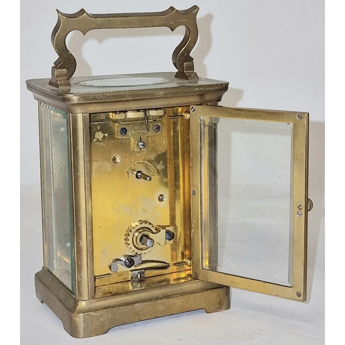 136 - Late 19th century French brass cased 8 day carriage clock with bevelled edged glass panels, ticking ... 