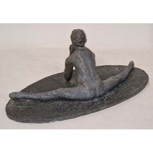 30 - A heavy cast metal sculpture of a stylized woman in an acrobatic pose 17cm tall 41cm wide.