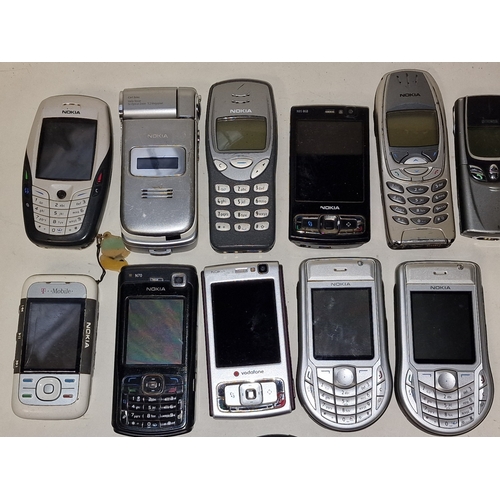 53 - Collection of vintage mainly Nokia mobile phones. 24 in total. A charger is also included.