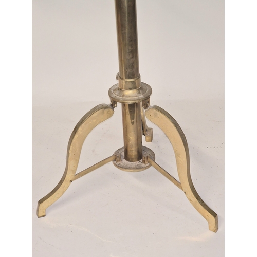 257 - A vintage brass telescope on tripod base of small proportions. Requires some attention.