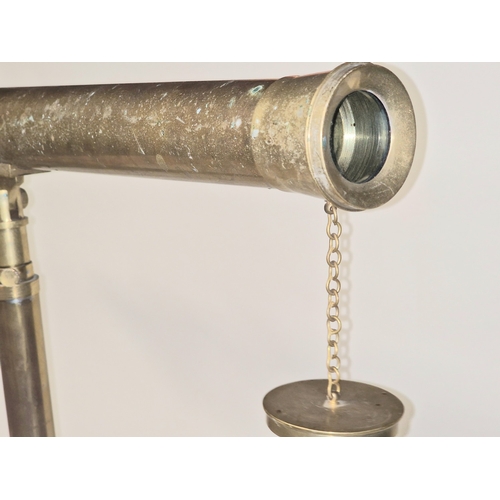 257 - A vintage brass telescope on tripod base of small proportions. Requires some attention.