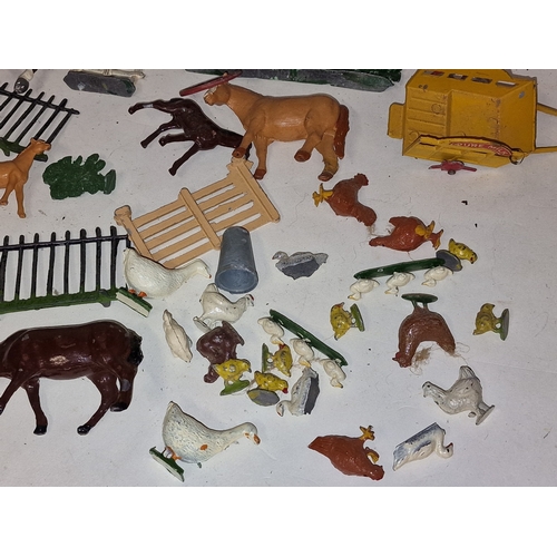 54 - A collection of vintage play worn lead farmyard animals and scenery to include Britains.