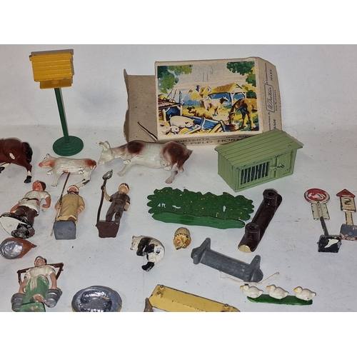 54 - A collection of vintage play worn lead farmyard animals and scenery to include Britains.