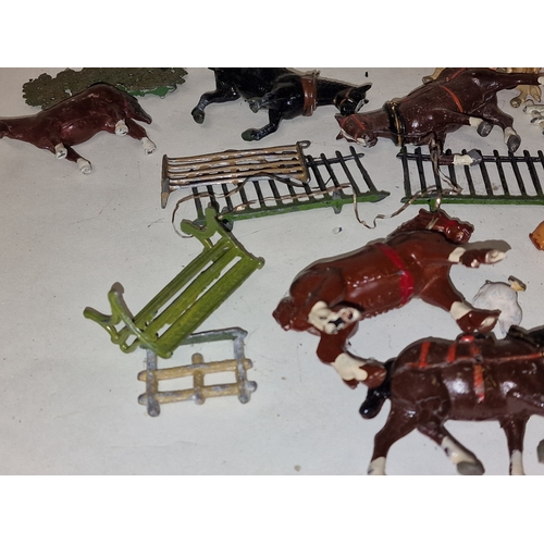 54 - A collection of vintage play worn lead farmyard animals and scenery to include Britains.