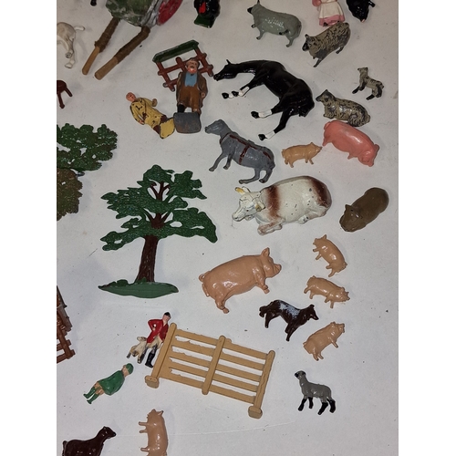 61 - A collection of vintage play worn lead farmyard animals and scenery to include Britains and Timpo.