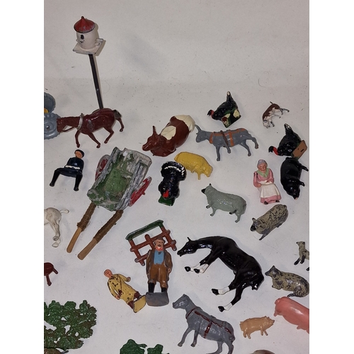 61 - A collection of vintage play worn lead farmyard animals and scenery to include Britains and Timpo.