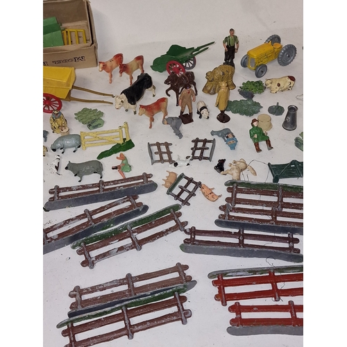 61 - A collection of vintage play worn lead farmyard animals and scenery to include Britains and Timpo.