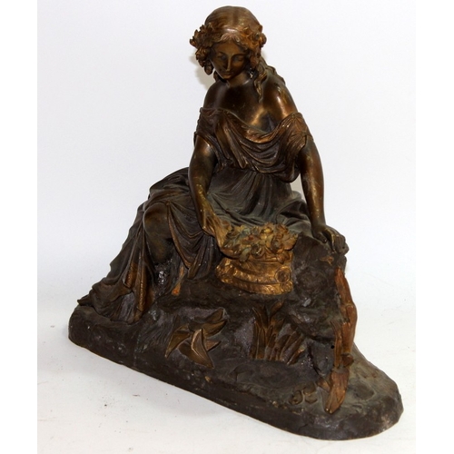 109 - Large antique cast metal figure of a classical woman sitting with a basket of flowers. 32cms across