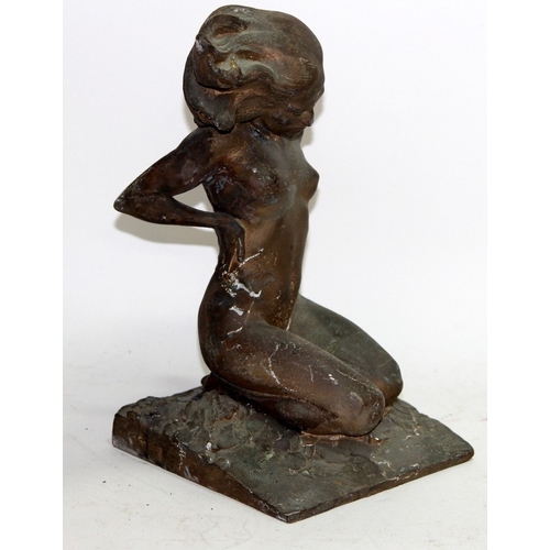 110 - Vintage cast metal figure of kneeling naked woman looking windswept and interesting. 30cms tall