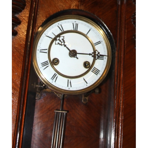 139 - Mahogany cased chiming wall clock with white enamel dial c/w key. working at time of listing