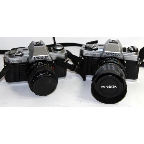 115 - A collection of vintage 35mm film SLR cameras, mostly with lenses, Olympus, Nikon, Minolta etc. Incl... 