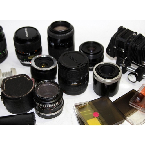 95 - A large collection  of vintage camera lenses and tele-converters, various brands and fittings