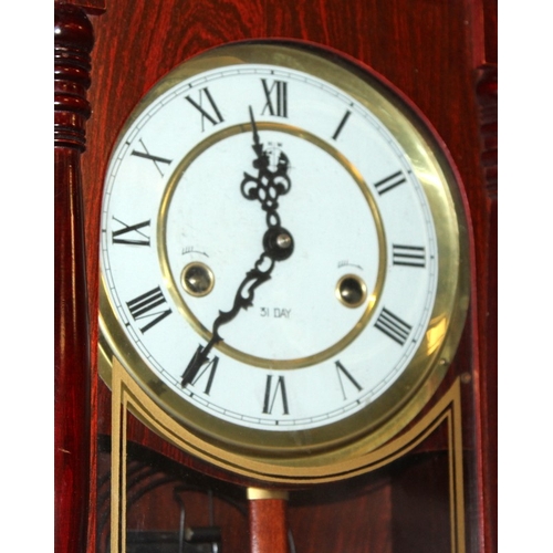 285 - Vintage mahogany cased 31 days striking wall clock with pendulum and key.