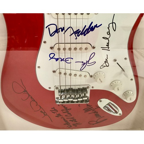 371 - THE EAGLES SIGNED AND FRAMED FENDER SQUIER STRATOCASTER ELECTRIC GUITAR. A very successful group who... 