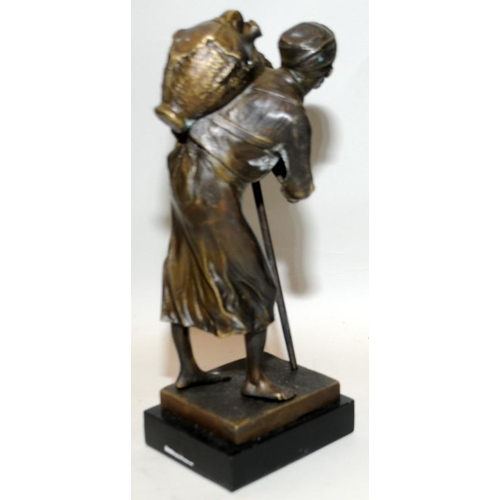 22 - PL Kamrollez: Small bronze of an Arab water seller with a stick. Signed. 24cms tall