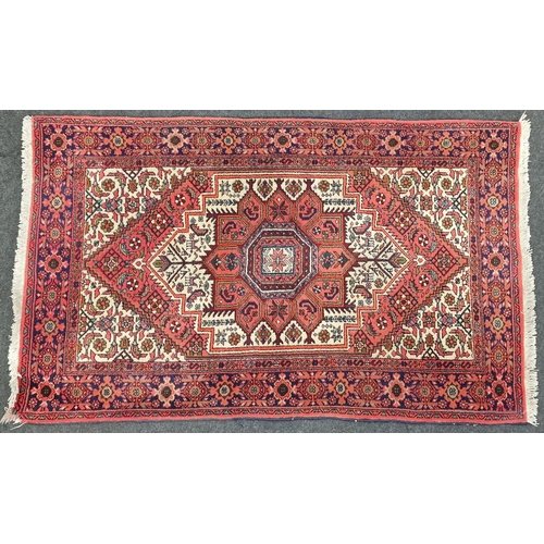 227 - A Persian patterned carpet 125x74cm.