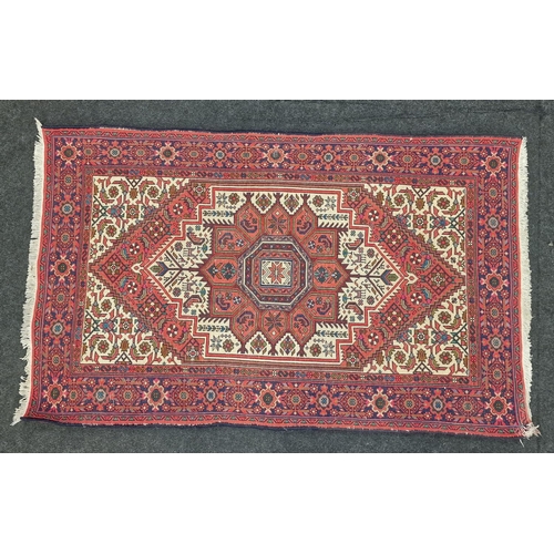 227 - A Persian patterned carpet 125x74cm.