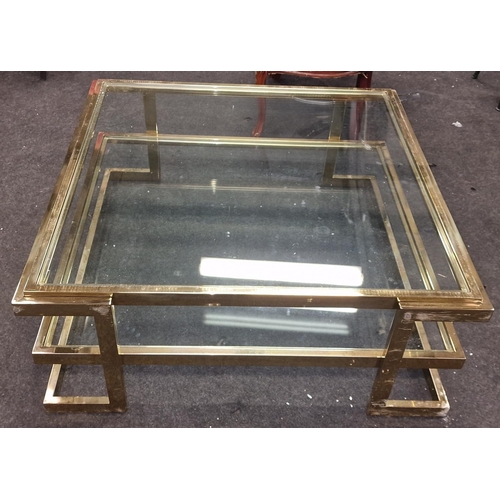 247 - A contemporary gold coloured metal oblong coffee table with glass top and shelf 42x101x101cm.