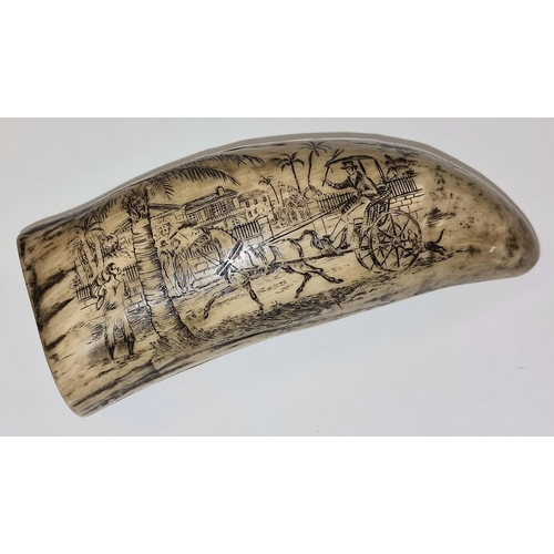 63 - A vintage scrimshaw style resin sperm whale tooth with decorative carvings 14cm in length.