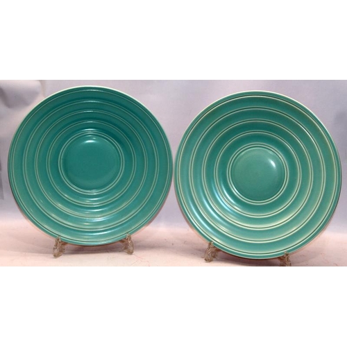 272 - Poole Pottery: A pair of large twin tone chargers with a raised pattern of concentric circles. one s... 