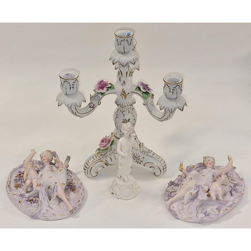 24 - Ornate Continental candlestick together with a pair of bisque wall plaques, and small figure (4)