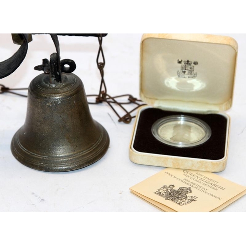 123 - An antique shop's door entry bell c/w a Sterling silver 1oz crown coin struck in 1980 with case and ... 