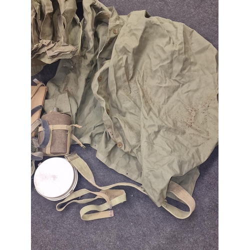 257 - Militaria: British Army Korean War era kit bag c/w raincoat other clothing, water bottle etc. 1956.