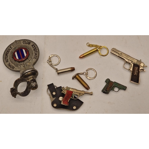 84 - A collection of novelty gun and bullet related items, keyrings etc together with a 