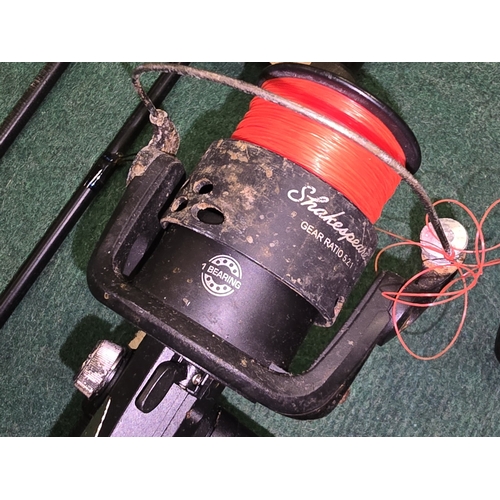 216 - 2 x fishing rods both with reels attached (REF P54).