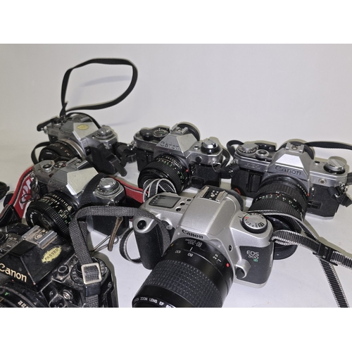 133 - 7 x Canon vintage 35mm SLR film cameras all with lenses attached.