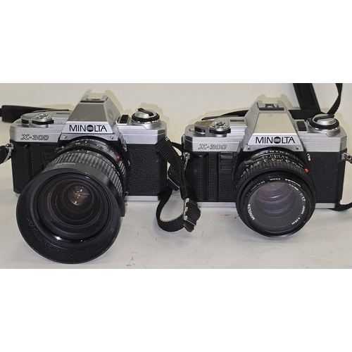 135 - 2 x Minolta X-300 vintage SLR 35mm film cameras both with lenses attached.