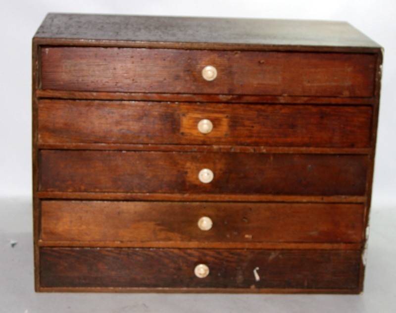 Five drawer table top chest of artisans drawers containing a quantity ...