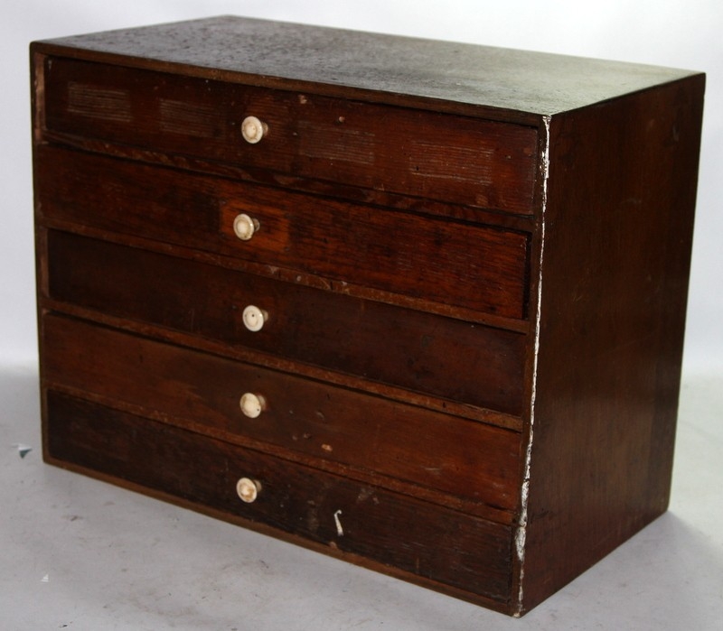 Five drawer table top chest of artisans drawers containing a quantity ...